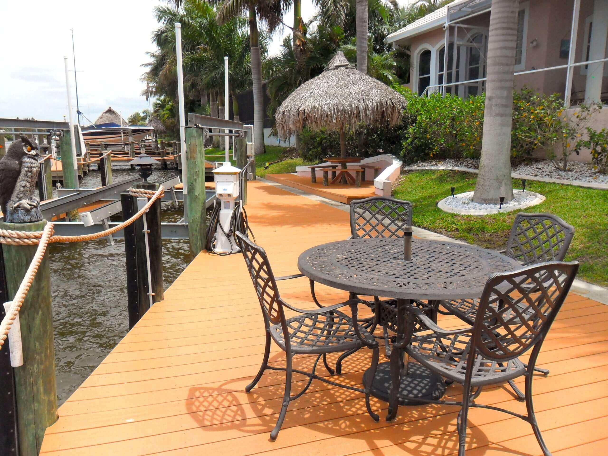 A patio with chairs and tables on the deck