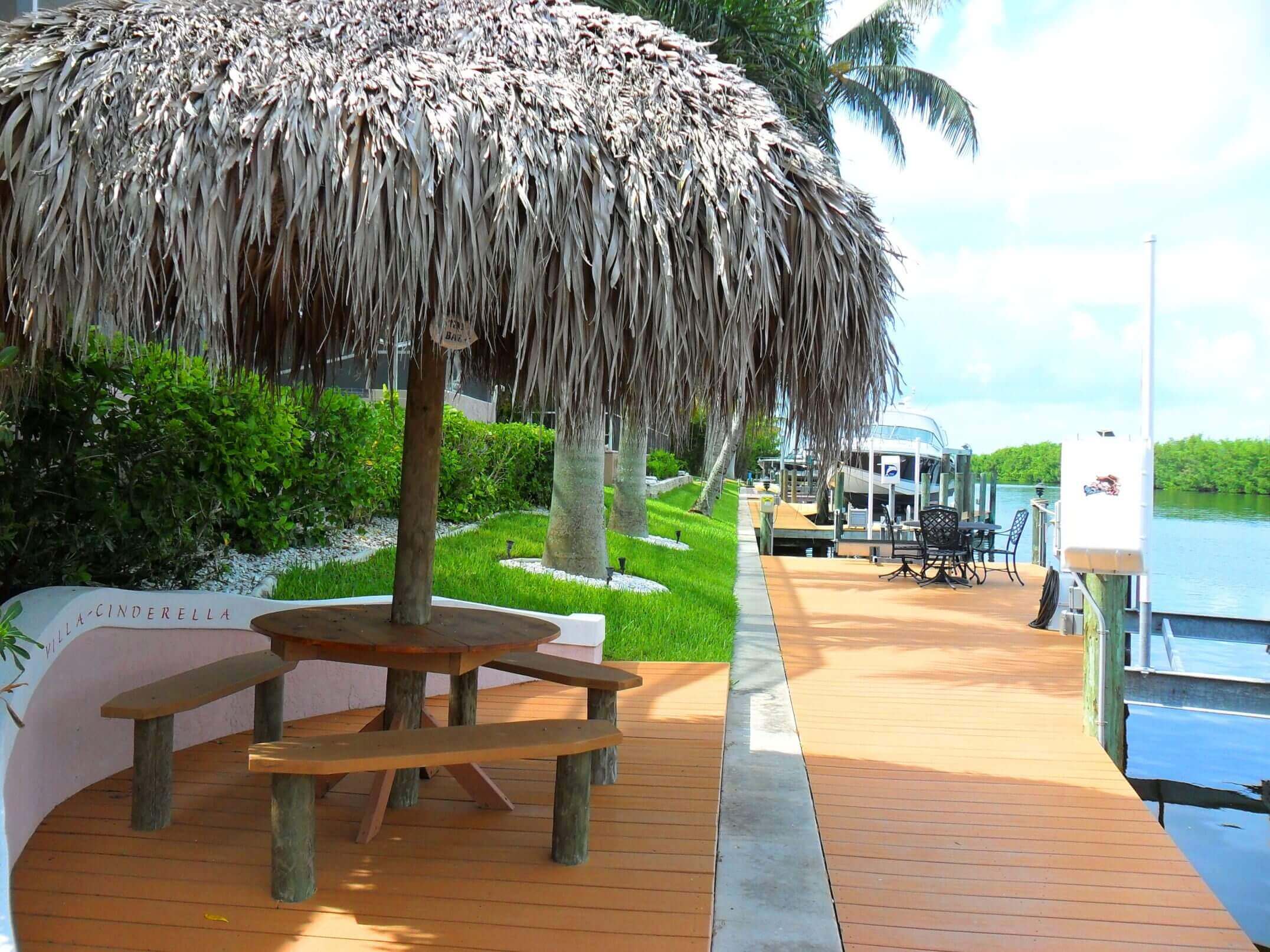 A large umbrella is on the deck of a dock.