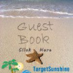 A guest book written in the sand on a beach.