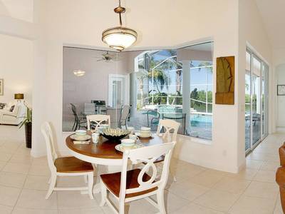 A dining room with a table and chairs in it