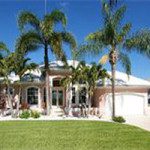 Sunlit suburban home with palm trees