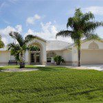Suburban ranch-style house with palm trees