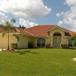 A house with a dog in the yard